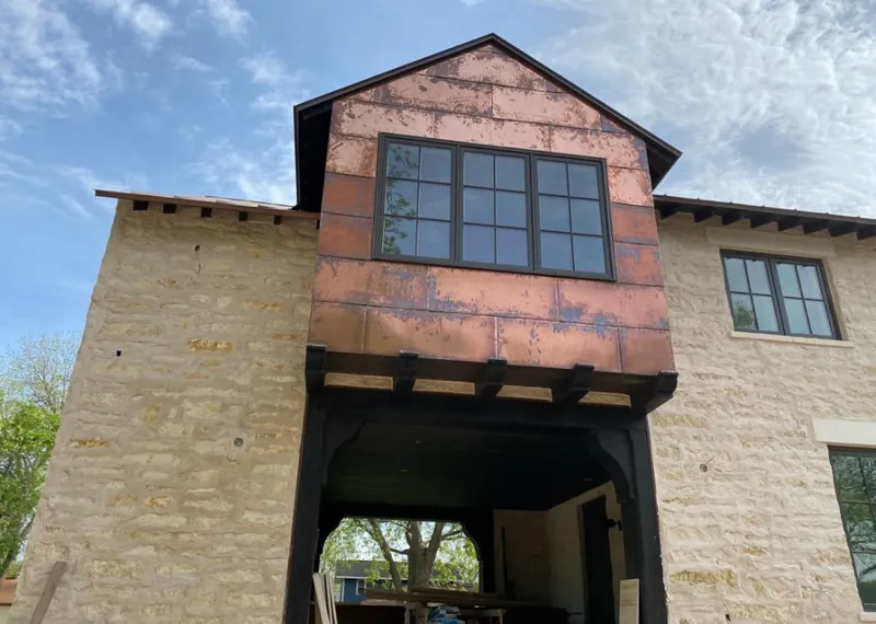 Copper metal panel facade on a stone building for Skylight Installation in Tallmadge